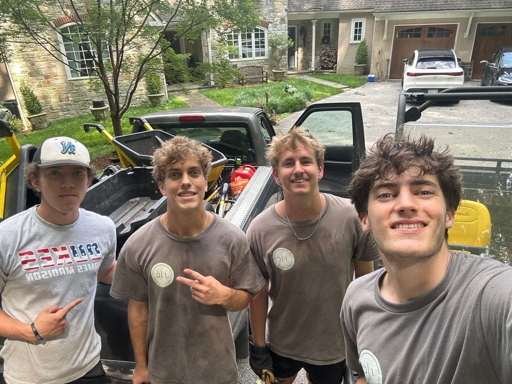 Shanin with three members of the Iconic Landscaping crew in front of a work truck